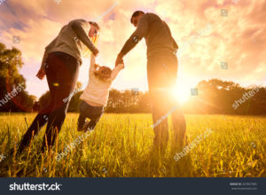 stock photo happy family in the park evening light the lights of a sun mom dad and baby happy walk at sunset 437807485